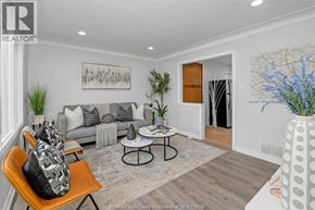 Windsor apartment for rent - A living room with a grey couch, a coffee table, and a painting on the wall.