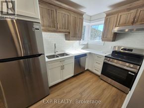 North Grenville multi-family for rent - A kitchen with wooden cabinets and a stainless steel refrigerator.