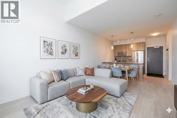Burnaby apartment for rent - A living room with a grey couch and a coffee table in front of it.