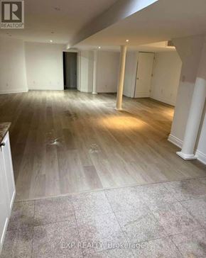 Vaughan (East Woodbridge) apartment for rent - A room with wooden flooring and white walls.