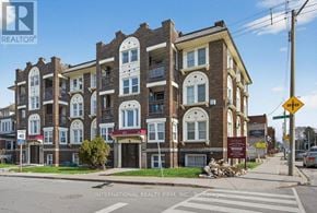 Hamilton (Stipley) multi-family for rent - A street view of a multi-story building with a sign for International Realty Firm, INC. on the bottom.