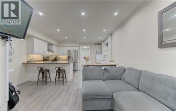 Kitchener townhouse for rent - A grey couch is in the middle of a living room.