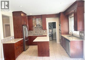 Richmond apartment for rent - A kitchen with wooden cabinets and stainless steel appliances.