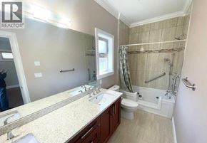 Richmond apartment for rent - A bathroom with a large mirror, double sinks, and a walk-in shower.