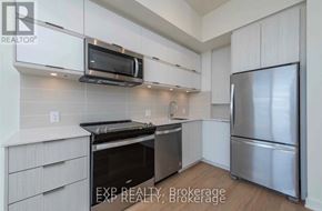 Toronto (Parkwoods-Donalda) condo for rent - A kitchen with white cabinets and stainless steel appliances.