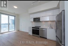 Toronto (Parkwoods-Donalda) condo for rent - A kitchen with white cabinets and stainless steel appliances.