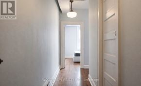 Oshawa (O'neill) apartment for rent - A hallway with a light fixture and a door on the right.