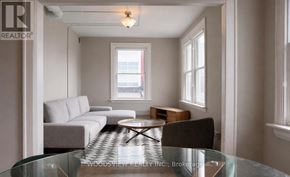 Oshawa (O'neill) apartment for rent - A living room with a glass table and a couch.