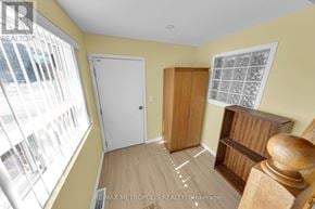 Richmond Hill (Crosby) apartment for rent - A room with a white door, a wooden cabinet, and a window with blinds.