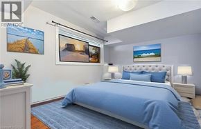 Welland apartment for rent - A bedroom with a large bed and pictures on the wall.