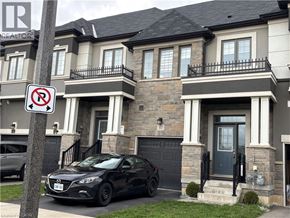 Brantford townhouse for rent - A black car is parked in front of a house with a no parking sign.