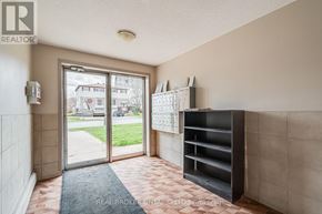 Orangeville condo for rent - A hallway with a door leading outside and a shelf on the wall.