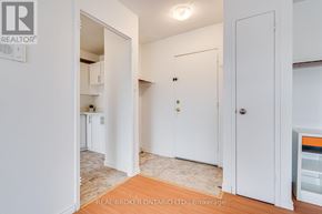 Orangeville condo for rent - A white door with a gold doorknob is open to a hallway.