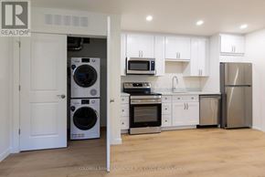 Port Colborne (Sugarloaf) multi-family for rent - A kitchen with white cabinets and stainless steel appliances.