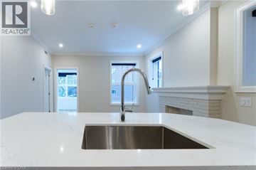 Hamilton apartment for rent - A modern kitchen with a stainless steel sink and white countertops.