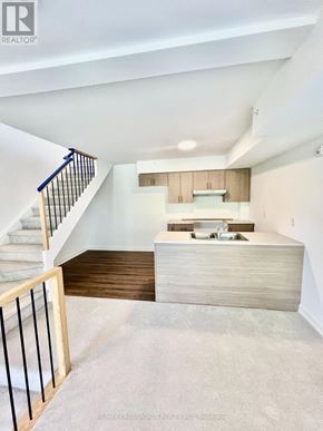 Whitby (Downtown Whitby) townhouse for rent - A modern interior space with a staircase leading to the upper level.