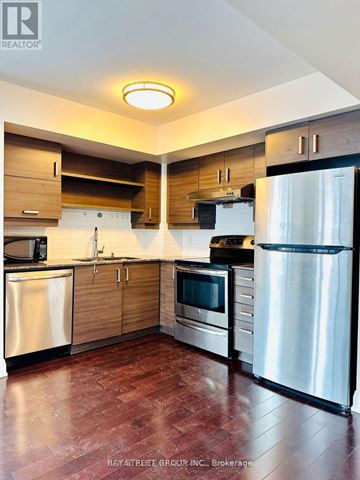 Markham (Unionville) condo for rent - A kitchen with a refrigerator on the right side.