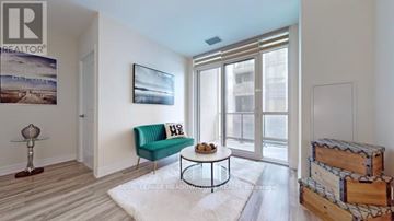 Vaughan (Concord) condo for rent - A living room with a green couch and a coffee table.