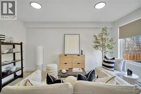 Windsor apartment for rent - A living room with a couch, a coffee table, and a mirror.