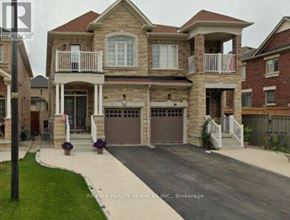 Brampton (Credit Valley) apartment for rent - A large house with a garage is shown in the image.