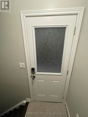 Brampton (Credit Valley) apartment for rent - A white door with a glass window and a handle.