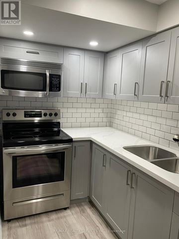 Brampton (Credit Valley) apartment for rent - A modern kitchen with a stainless steel oven and microwave.