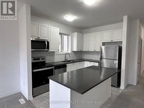 Southgate apartment for rent - A kitchen with a black counter top and stainless steel appliances.
