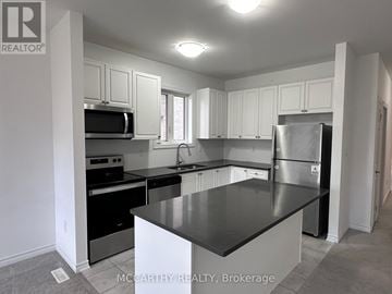 Southgate apartment for rent - A kitchen with a black counter top and stainless steel appliances.
