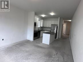 Southgate apartment for rent - A spacious room with a kitchenette and a bar area.