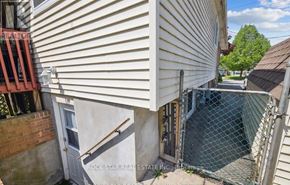 Welland (Lincoln/Crowland) apartment for rent - A view of a building with a fence and a sign that says "REALTOR".
