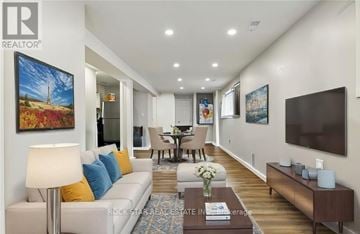 Welland (Lincoln/Crowland) apartment for rent - A living room with a white couch and a painting on the wall.
