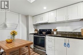 Welland (Lincoln/Crowland) apartment for rent - A kitchen with a wooden table and a stove top oven.