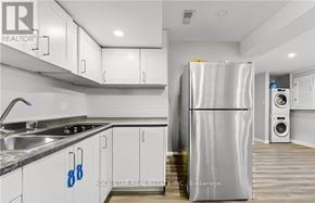 Welland (Lincoln/Crowland) apartment for rent - A modern kitchen with white cabinets and a stainless steel refrigerator.