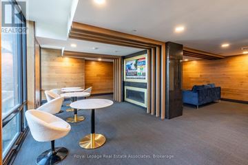 Waterloo condo for rent - A modern office space with a wood panelled wall and a television screen.