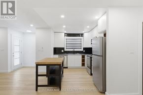 Pelham (Fonthill) duplex for rent - A modern kitchen with a wooden table and stainless steel appliances.