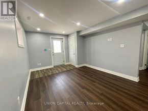 Whitchurch-Stouffville (Stouffville) apartment for rent - A room with wood flooring and white walls, with a door and a window.