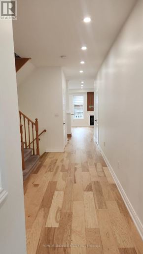 Richmond Hill (Oak Ridges) apartment for rent - A long hallway with wood floors and white walls.