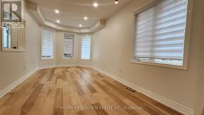 Richmond Hill (Oak Ridges) apartment for rent - A room with wooden flooring and white walls.