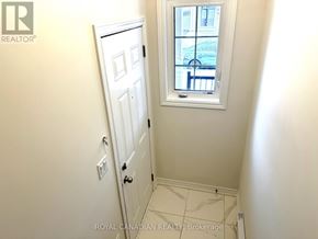 Barrie multi-family for rent - A white door is in a room with a window.