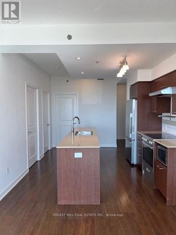 Toronto (Forest Hill South) house for rent - A kitchen with a sink and a wooden island.
