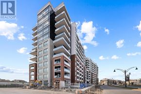 Clarington (Bowmanville) condo for rent - A large building under construction with a clear blue sky in the background.