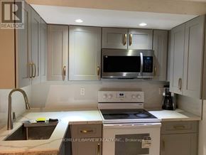 Richmond Hill (Harding) apartment for rent - A kitchen with a stove, microwave, and oven.