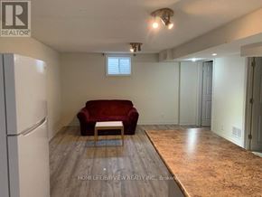 Richmond Hill (Harding) apartment for rent - A living room with a red couch and a wooden coffee table.