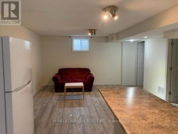 Richmond Hill (Harding) apartment for rent - A living room with a red couch and a wooden coffee table.