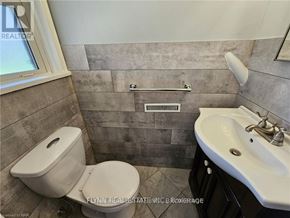 Welland (Lincoln/Crowland) apartment for rent - A bathroom with a toilet, sink, and a window.
