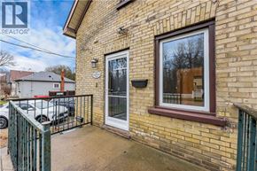 Kitchener apartment for rent - A brick house with a window and a door is for sale.