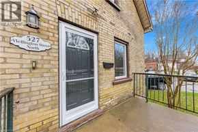 Kitchener apartment for rent - A brick house with a window and a sign that says 527 Wellington Street North.