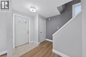 Kitchener apartment for rent - A hallway with a white door and a window.