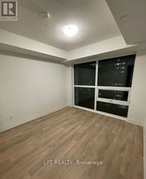 Toronto (Woburn) condo for rent - A room with wooden flooring and a window with blinds.