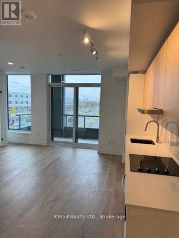 Toronto (York University Heights) condo for rent - A kitchen with a sink and a window overlooking a parking lot.